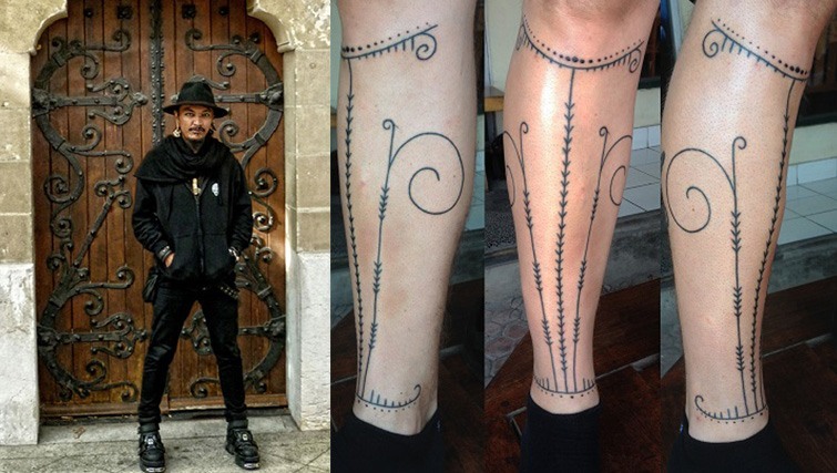 Artist Albar Tikam and an example of his favourite artwork, done using the traditional Balinese stick and poke method.
